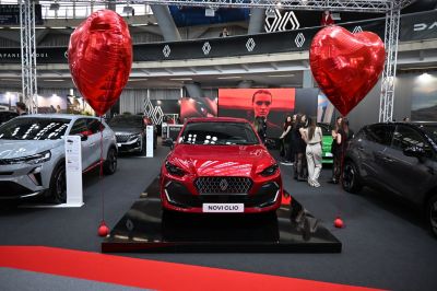 Red hatchback front view with distinct grille and headlights