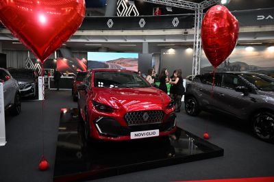Red hatchback front view with black sporty grille and sleek headlights