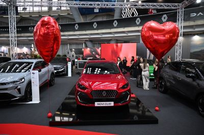 Red hatchback with distinctive front grille and modern headlights
