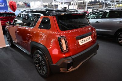Rear and side profile of electric crossover SUV with distinctive tail lights and black alloy wheels