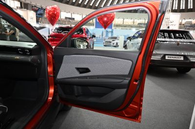 Front door interior panel with fabric, handle, and controls