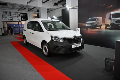 White van with black grille and steel wheels in exhibition space