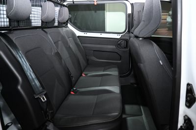 Rear passenger seat row with black fabric upholstery and headrests