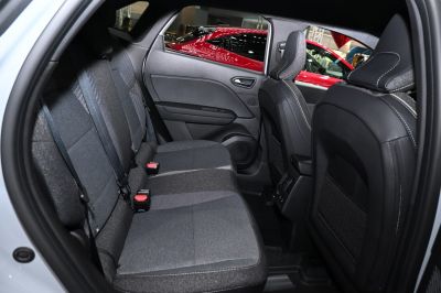 Rear fabric seats with seat belts inside a modern car interior