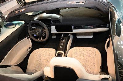 Luxury car interior with carbon fiber center console and modern steering wheel