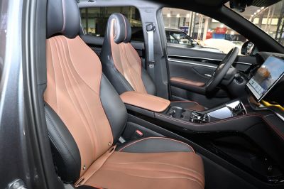 Two-tone leather seats with stitched design and modern dashboard touchscreen.