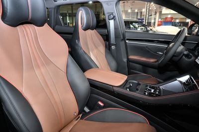 Two-tone leather front seats with perforation and red stitching.