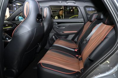 Leather rear seats with orange stitching and spacious rear passenger area.