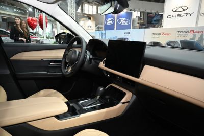Beige car interior with large touchscreen and gear lever