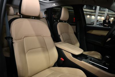 Beige leather perforated seats with modern center console and armrest