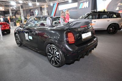 Rear view of convertible with folded soft top and stylish alloy wheels