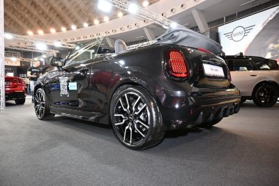Rear view of black convertible with folded soft-top and black alloy wheels