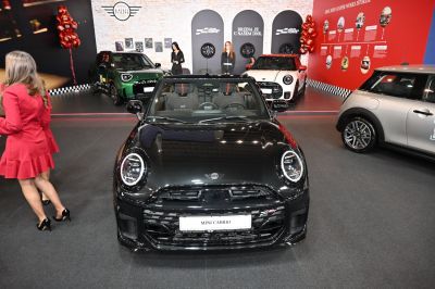 Front view of black convertible with LED circular headlights and sporty grille.
