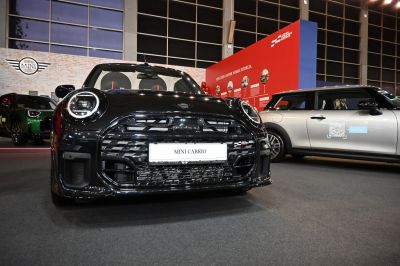 Front view with LED headlights and grille of a black convertible