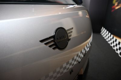 Close-up of Mini emblem and rear badge on silver surface