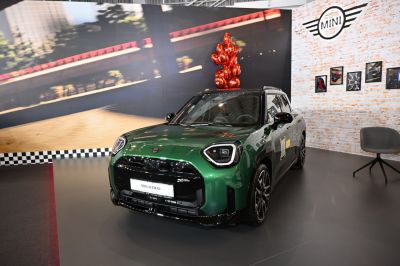Green vehicle with angular headlights and bold front grille.