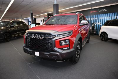 Red pickup with bold front grille and LED headlights