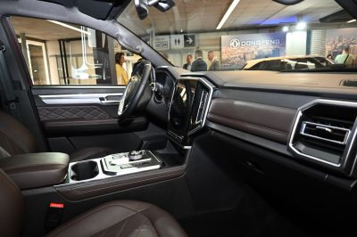 Modern vehicle interior with large touchscreen and quilted leather upholstery