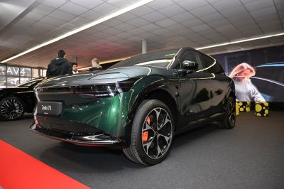 Front view of a car with sleek headlights and multi-spoke alloy wheels