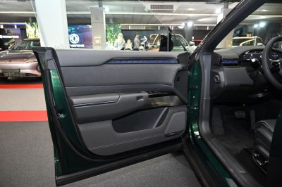 Modern car door panel and dashboard interior with controls and lighting