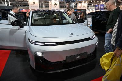 Front view of sleek car with LED strip headlights and smooth aerodynamic bumper