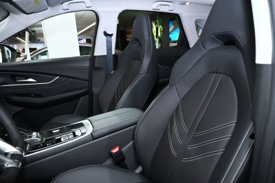 Black leather seats with stitching and modern center console design.