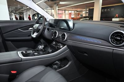 Modern car interior with digital dashboard and circular air vents