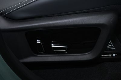 Close-up of power seat adjustment controls on car interior