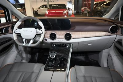 Interior dashboard with digital display, steering wheel, wood trim accents