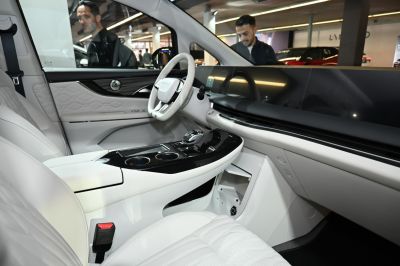 Luxurious car interior with digital dashboard and white quilted seats