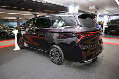 Luxury minivan rear with LED taillights and multi-spoke wheels
