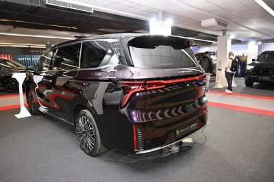 Rear view of a sleek vehicle with continuous LED tail light strip.