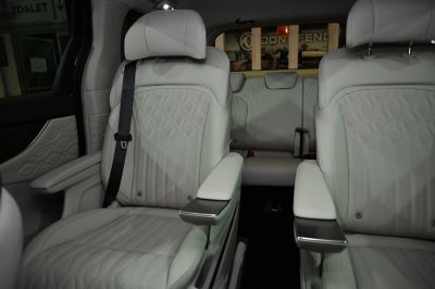 Beige leather seats with detailed stitching and armrests