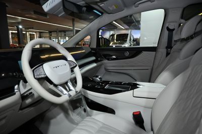 Luxury white leather seats and modern dashboard with steering wheel controls