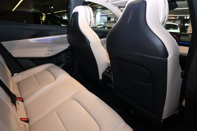 Modern rear seat interior with black and white leather upholstery.
