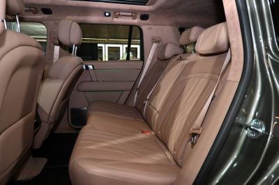 Plush tan leather rear seats with detailed stitching and spacious layout