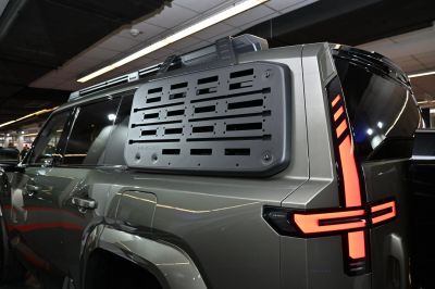 Rear side with rugged cargo panel and vertical LED tail light.