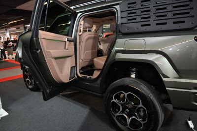 Rear door open, beige interior seats, unique wheel design