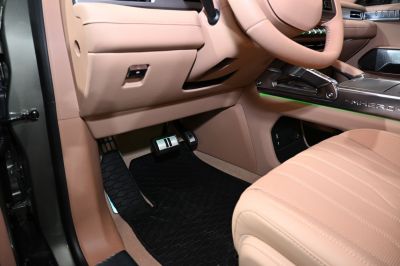 Beige leather seats and pedal area in a modern car interior