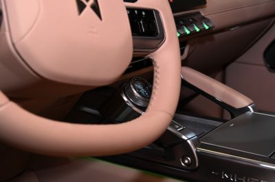 Beige leather steering wheel and control dial with illuminated buttons