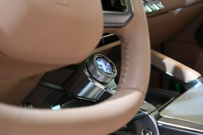 Luxury car interior with embedded watch on leather steering wheel