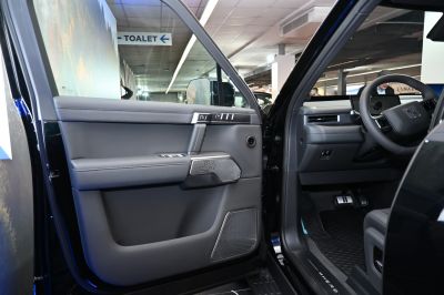 Driver-side door panel with controls and modern dashboard view