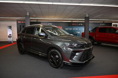 SUV front side view with black alloy wheels and aggressive grille