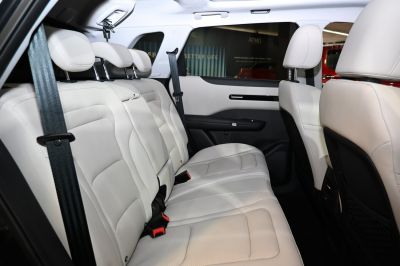 Spacious rear seats with leather upholstery, headrests, and seat belts