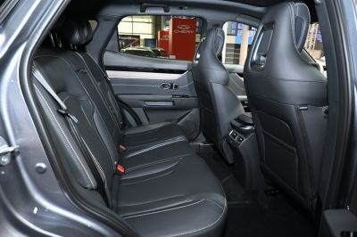 Leather rear seats with detailed stitching and rear cabin interior.
