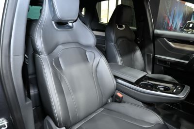 Black leather bucket seats with detailed stitching and a sleek center console