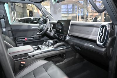Modern car interior with large touchscreen and sleek dashboard.