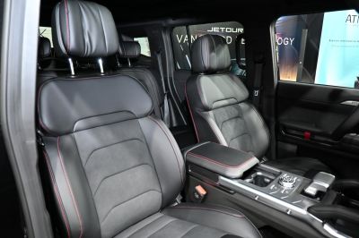 Luxury leather seats with red stitching and modern center console layout