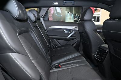 Spacious rear seat area with black leather upholstery and detailed stitching.