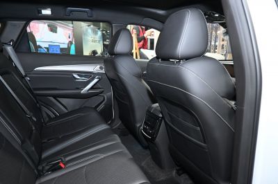 Rear seating and door panel with black leather upholstery and white stitching
